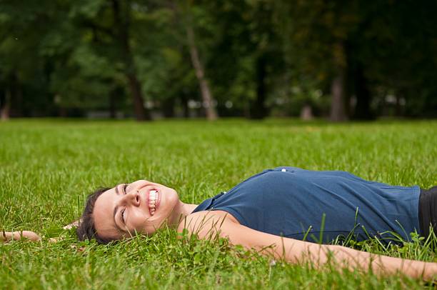 istock Enjoying life - woman lying in grass 152958154