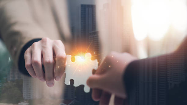 istock Businessman holding a puzzle piece to find a business solution ,Connecting success and problem solution from creativity ,strategic planning to develop organization ,success and strategy concept 1529581729
