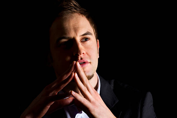 istock Businessman with folded hands looking up. 152958213