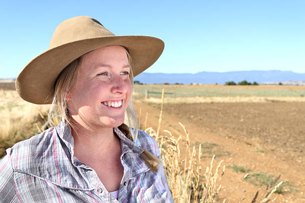 Farmer Woman A happy farmer woman looks towards the horizon on a hot day. farmer-drought-australia stock pictures, royalty-free photos & images