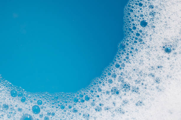istock Detergent foam bubble on water. Blue background, Soap sud 1529582807