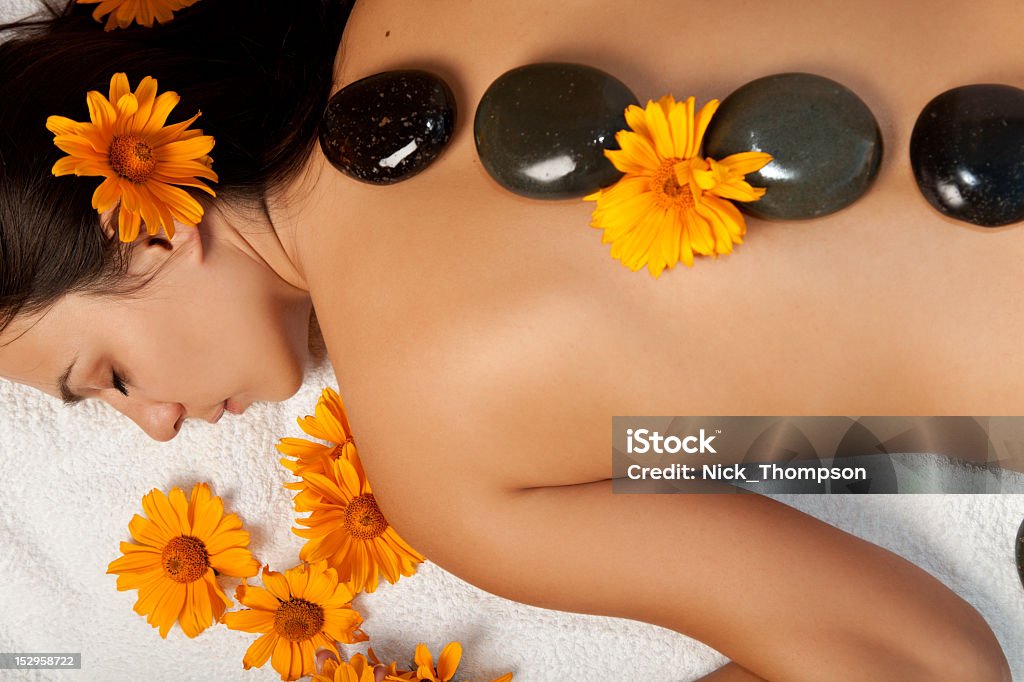 Woman receiving a hot stone massage at the spa salon Stone therapy. Woman getting a hot stone massage at spa salon Adult Stock Photo