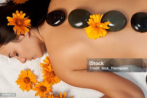 Woman Receiving A Hot Stone Massage At The Spa Salon Stock Photo - Download Image Now