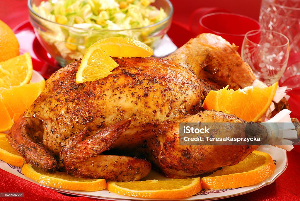 roasted whole chicken with oranges plate with delicious  roasted whole chicken with oranges for party Baked Stock Photo