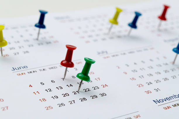 istock Thumbtack pins on a calendar 1529589745
