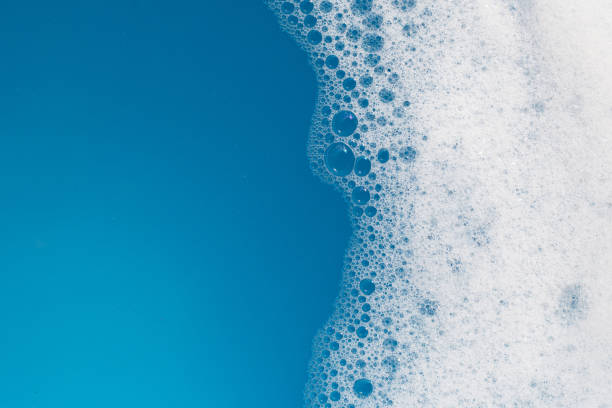 istock Detergent foam bubble on water. Blue background, Soap sud 1529596423