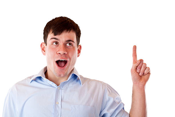 istock Excited, surprised young man pointing and looking up at copyspace 152960051