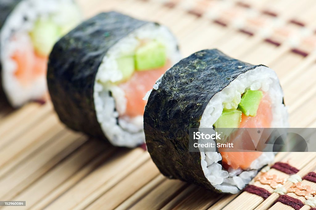 sushi sushi in row on bamboo mat Avocado Stock Photo