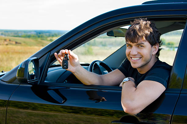 istock happy man showing keys in car 152960318