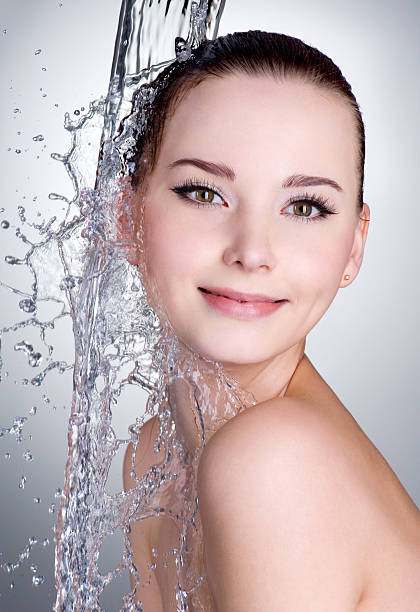 istock Smiling woman under stream of water 152960324