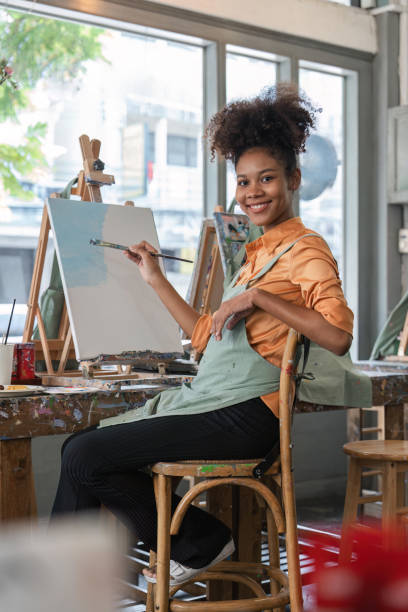 istock african american female artist painting on canvas doing some art projects on her studio workshop 1529604319