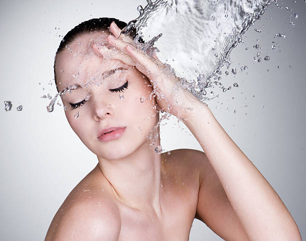 istock Water falling on the beautiful sensuality woman face 152960434