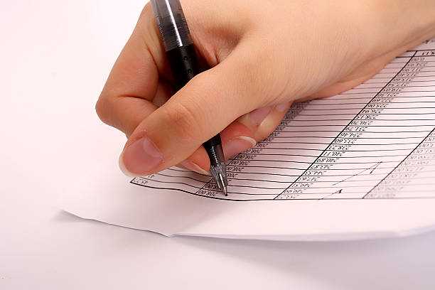 female hand writing a document stock photo