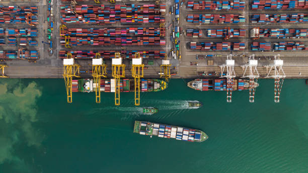 cargo ship and truck at seaport waiting for container dock by crane shipment harbor loading container import  export commercial trade business logistic  transportation international