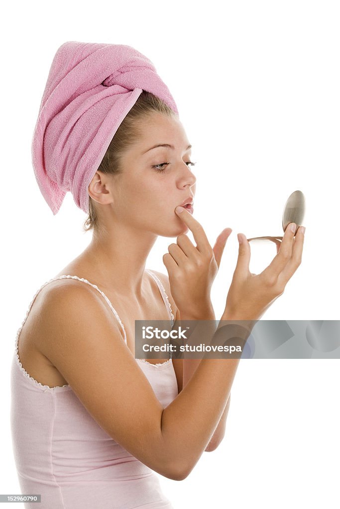 Beautiful girl looking in a hand mirror Young woman looking into mirror Examining Stock Photo