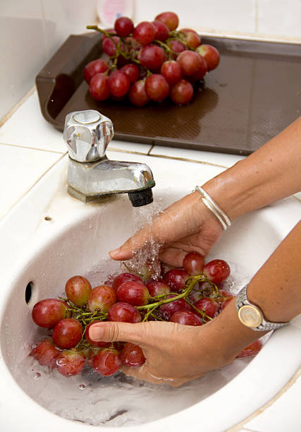 istock cleaning grapes with water rubbing 152960977