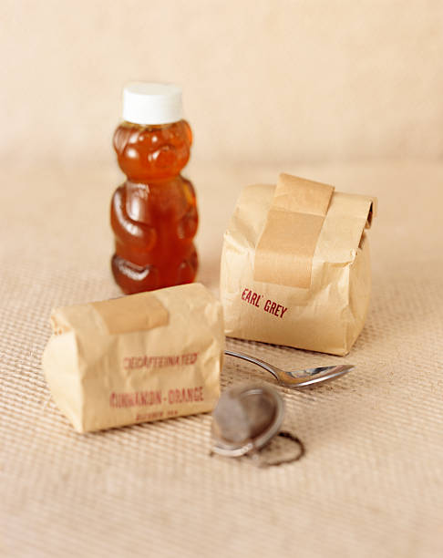 Bags of tea, honey and strainers stock photo