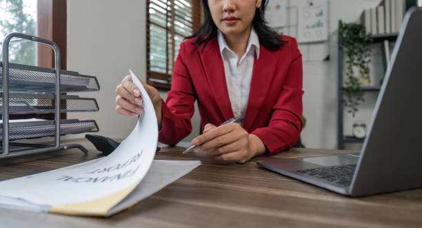 istock business woman writing document down notes company income and expenses while sitting at table in office 1529618872