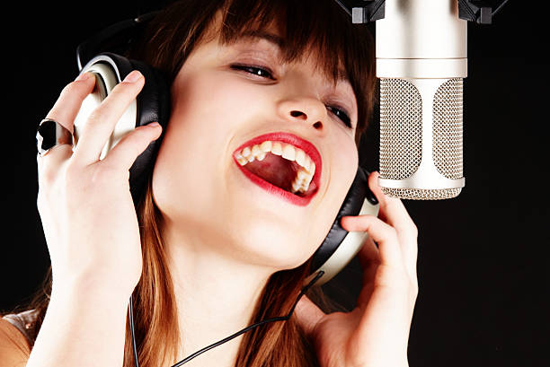 istock girl singing to the microphone in a studio 152962000