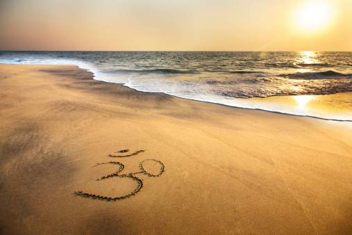 Símbolo Om en la playa photo