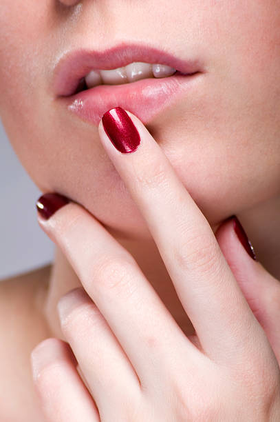 istock Woman lips and fingers 152963538