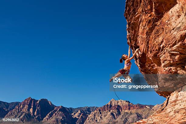 Female Rock Climber Clinging To A Cliff Stock Photo - Download Image Now - Rock Climbing, Extreme Sports, Dedication