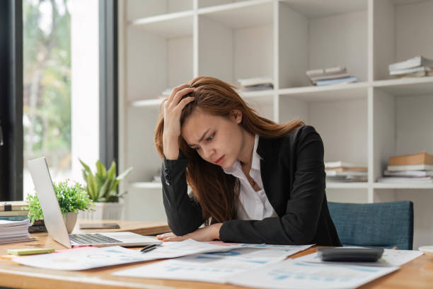 istock Stress, anxiety and burnout with a business woman at work using a laptop while suffering from a headache 1529636598