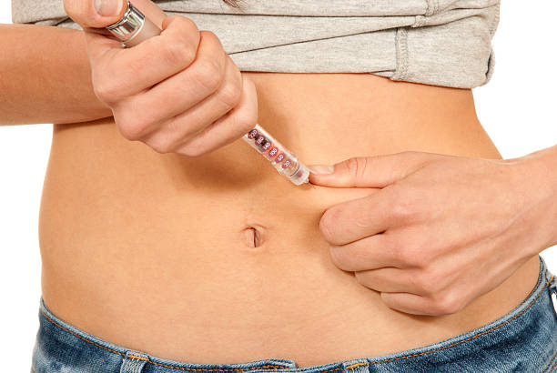 istock Woman making insulin shot by syringe pen 152963754