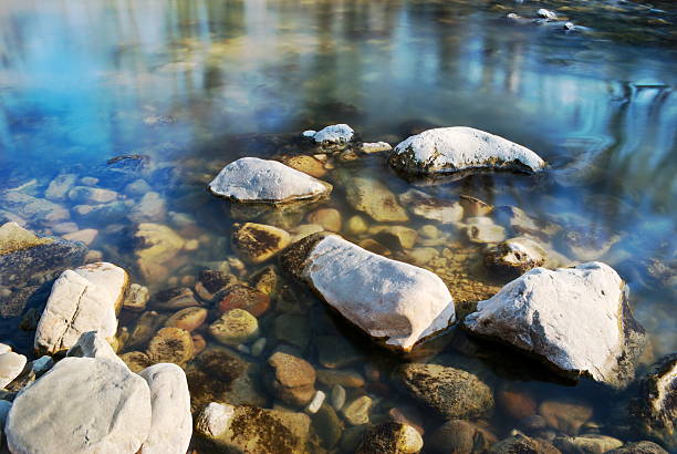 Stones in flowing river stock photo