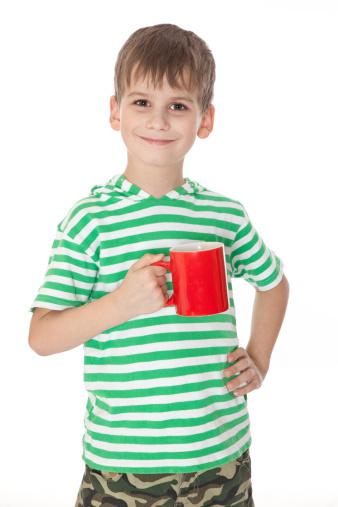 Boy holding a red cup isolated on white