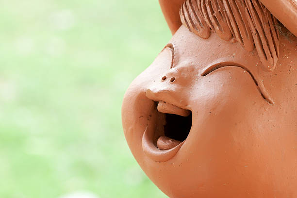 Closes up baked clay child doll