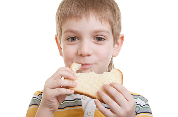istock Boy eating piece of bread 152964042