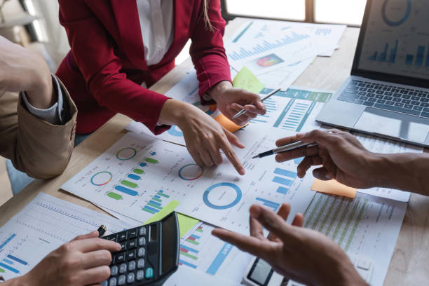 istock Analyst team in office analyzing financial data analysis for marketing strategy in office, dashboard paper format with graph and chart to optimize performance and management 1529647567