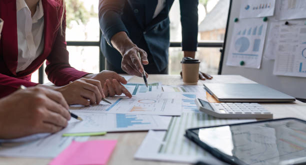 istock Analyst team in office analyzing financial data analysis for marketing strategy in office, dashboard paper format with graph and chart to optimize performance and management 1529647594