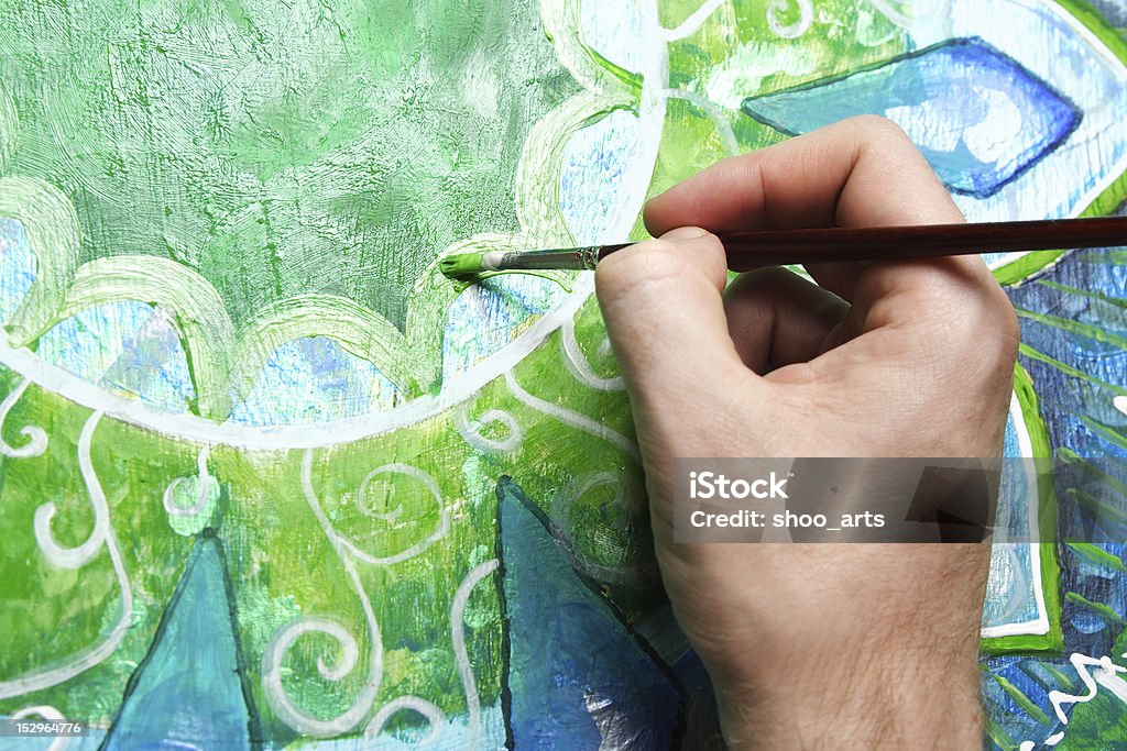 closeup of man painting green picture with circle pattern closeup of man painting green picture with circle pattern, mandala of anahata chakra Abstract Stock Photo