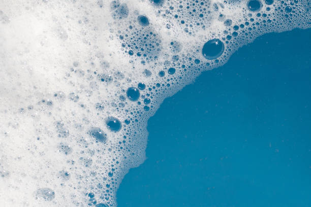 istock Detergent foam bubble on water. Blue background, Soap sud 1529648558