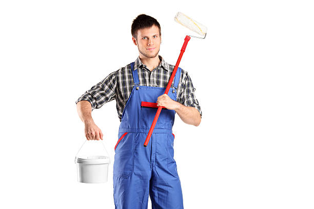 istock Smiling worker man holding a paint roller and bucket 152966872