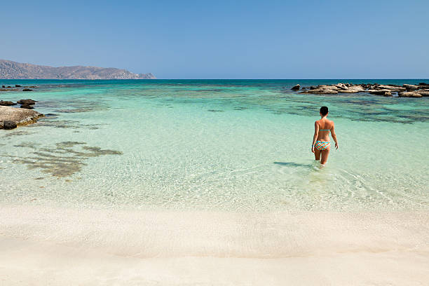 frau baden in elafonisi beach - sea swimming greece women stock-fotos und bilder