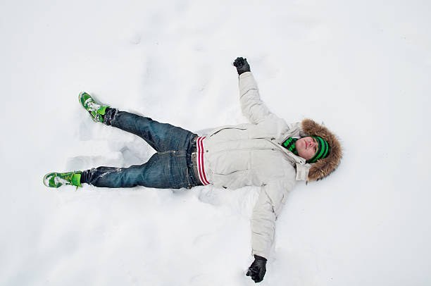 istock young man, lying in the snow 152967204