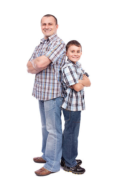 Father and son hugging in autumn park, shallow depth of field. Active family vacation