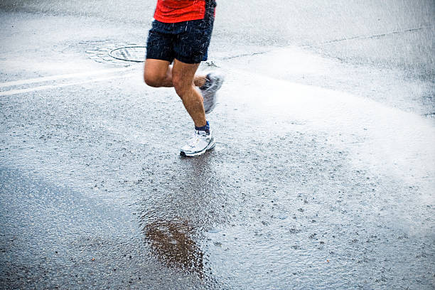 istock Marathon runner in rain on city street 152967465