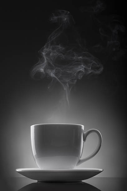istock white cup with hot liquid and steam on black 152968082