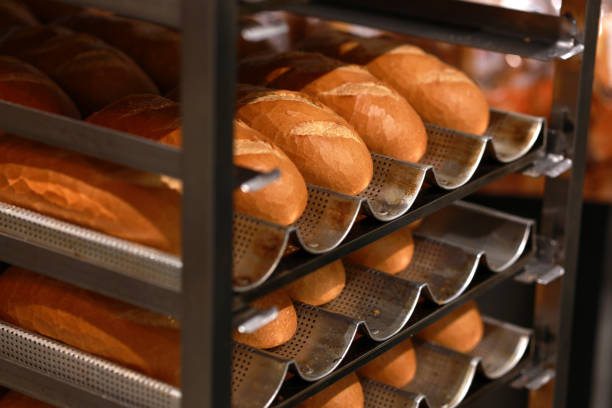 istock Freshly baked Vietnamese Banh Mi bread loaves placed on a cooling rack. 1529687462