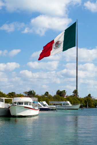 The large Mexico flag as seen from the back bay marina in Cancun, Mexico