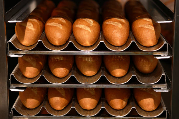 istock Freshly baked Vietnamese Banh Mi bread loaves placed on a cooling rack. 1529694064
