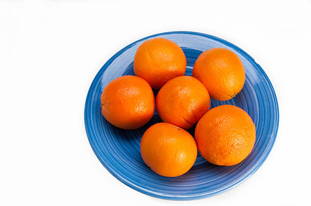 Blue plate with six oranges stock photo