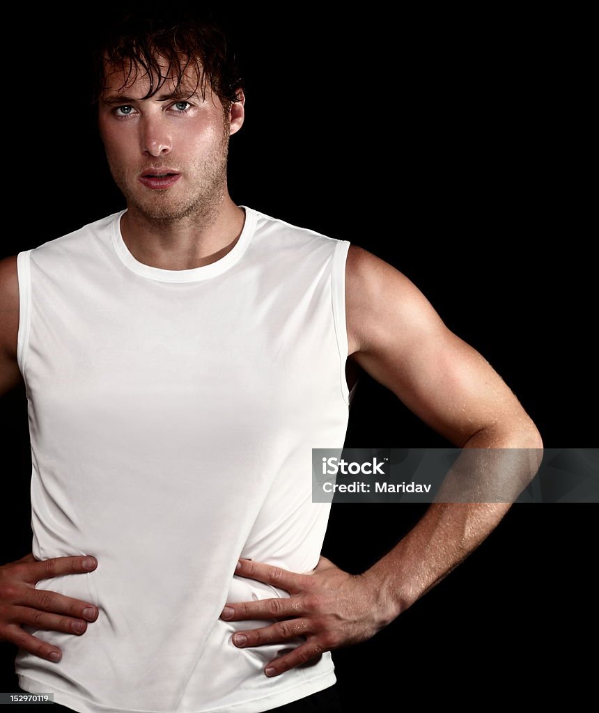 Athlete young man portrait sporty athlete man portrait on black background. Young muscular fit fitness man isolated on black background. Caucasian model. Sweat Stock Photo