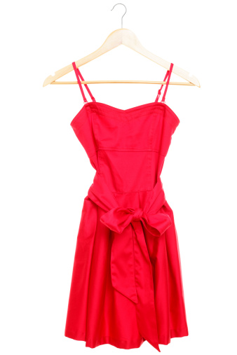 Red dress on hanger isolated on white background. See more
