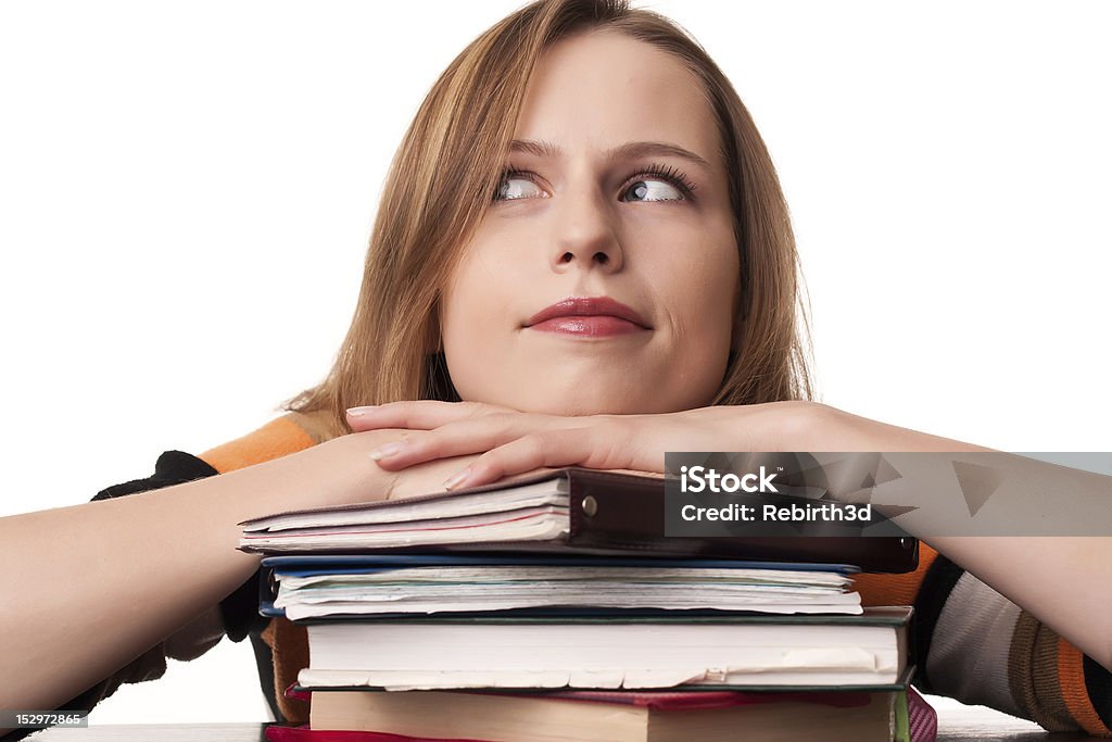 Young student girl with head on top of books pile Young student girl with head on top of books pile on white background Adult Stock Photo