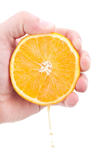 istock Juicy orange section in hand 152972924